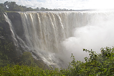 The River Zambezi crashes over the Victoria Falls waterfall (Mosi-oa-Tunya), UNESCO World Heritage Site, on the border of Zimbabwe and Zambia, Africa