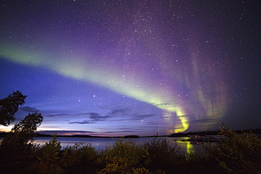 The Northern Lights (aurora borealis) in the night sky above Lake Egenolf in northern Manitoba, Canada, North America