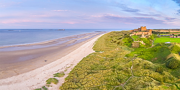 Aerial view by drone of Bamburgh Castle, Bamburgh, Northumberland, England, United Kingdom, Europe