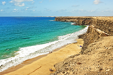 Volcanic rock headland and sandy beach south of this village on the north west coast, El Cotillo, Fuerteventura, Canary Islands, Spain, Atlantic, Europe