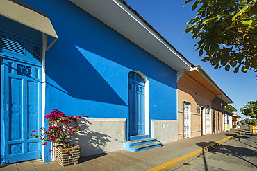 Colourful painted buildings on popular Calle de la Calazada street of cafes in centre of this historic city, Granada, Nicaragua, Central America