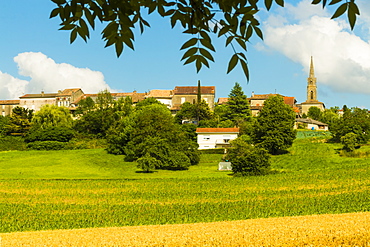 View over fields in summer towards this quiet hilltop village near Duras, Levignac-de-Guyenne, Lot-et-Garonne, Aquitaine, France, Europe