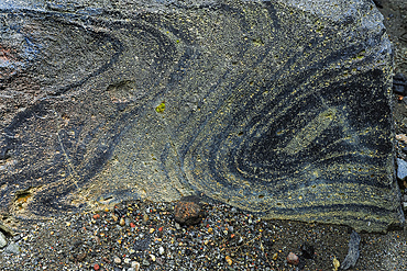 Swirly flow lines of volcanic glass (obsidian) within a piece of lava at Mount Lokon volcano near Tomohon city, Gunung Lokon, Tomohon, North Sulawesi, Indonesia, Southeast Asia, Asia