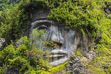 Large carved face at Bukit Kasih, a volcanic tourist park with fumarole fields, a world peace themed tower and worship houses of five major religions, Bukit Kasih, Minahasa, North Sulawesi, Indonesia, Southeast Asia, Asia