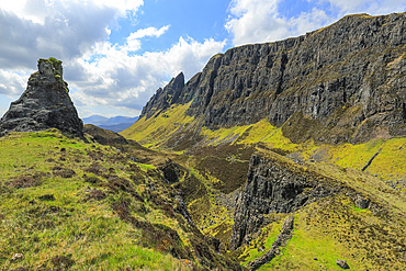 Towering cliffs of basalt lava over Jurassic sediments at the Quirang, the famous hike & scenic attraction in the far north east of the island. Quirang, Staffin, Skye, Inner Hebrides, Scotland, UK