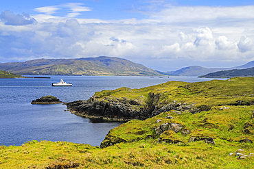 View South across Balmeanach Bay from Braes peninsula to Isle of Scalpay with the Calmac ferry crossing from Raasay Island to Sconser on Skye, The Braes, Portree, Skye, Inner Hebrides, Scotland, United Kingdom, Europe