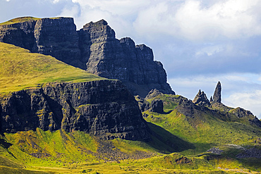 Basalt lava cliffs over Jurassic sediments at the Trotternish Ridge tower over this landslide landscape and the Old Man of Storr, Skye's famed scenic rock spire. Old Man of Storr, Trotternish Peninsula, Inner Hebrides, Scotland, UK