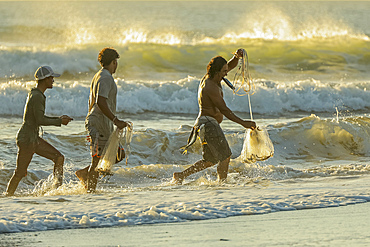 Men with throw nets & freshly caught fish at Nosara Boca (river mouth), a popular fishing spot for locals. Boca Nosara, Nosara Beach, Guanacaste, Costa Rica