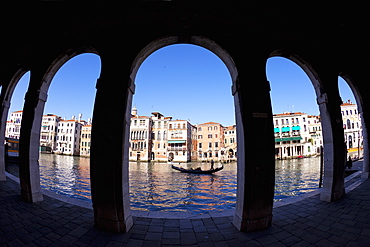 Gondola and gondolier taken through arches of the Rialto Market area, San Polo, Venice, UNESCO World Heritage Site, Veneto, Italy, Europe