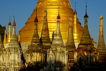 Bas of a big golden stupa with many small stupas in front Pindaya Shan State Burma