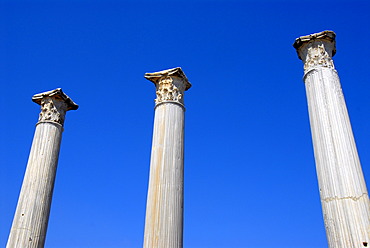 Three ancient pillars with blue sky Gymnasium archaeological site Salamis North Cyprus