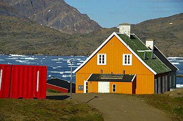 Colourful house at a fjord in settlement Ammassalik Eastgreenland