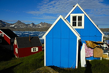 Blue and red wooden house in settlement Ammassalik Eastgreenland