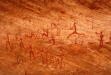 Neolithic rock drawing of humans and animals at hunt Acacus Libya