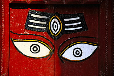 Red painted door with two eyes watching Durbar Square Kathmandu Nepal