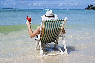 Man with cocktail at seashore