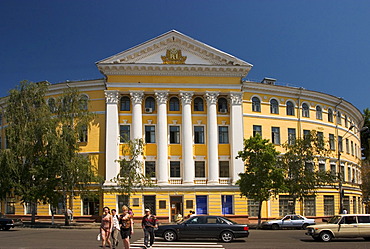 Ukraine Kiev district Podil Kontraktova Place oldest place of town view to the historical building of Mohyla Akademie round building with column peoples tourists cars blue sky 2004