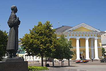 Ukraine Kiev district Podil Kontraktova Place oldest place of town view to the historical building of contrakts and the bronce statue of Hryhorij Skovoroda 1794+ parc and trees blue sky 2004