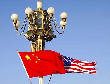 Flags of the People\'s Republic of China and the United States flutter jontly at lamp post of Tiananmen Square, State visit by President Bush, November 2005, Beijing China