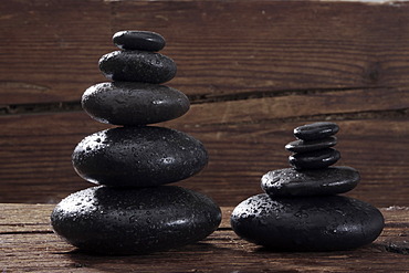 Hot stone massage stones on a wooden beam