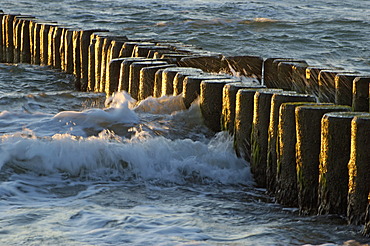 Waves breaking at a groyne at dusk Baltic Sea Germany