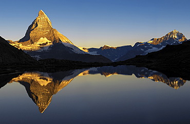 The Matterhorn is reflected in the Riffelsee near Zermatt, canton Wallis, Switzerland