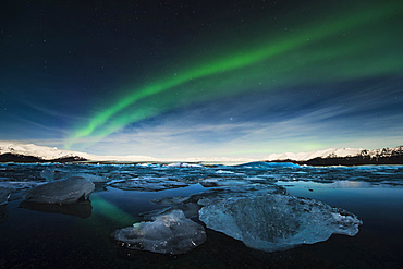 Chunks of ice in the water at the blue hour with polar lights, JÃ¶kulsÃ¡rlÃ³n lake, Vik, Iceland, Europe