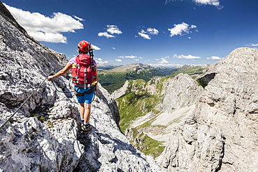 Mountaineer ascending to Cima d'Auta on the Via Ferrata Paolin Piccolin at Colmean, Falcade, Via Ferrata in Biois, Dolomites, Province of Belluno, Italy, Europe