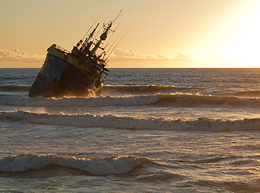 Shipwreck at sunset at Laayoune Plage, Western Sahara, Southwest Morocco, Africa