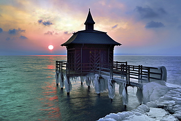 Bathhouse on pier with icicle in winter at sunrise, Lake Neuchâtel, Gorgier, Canton Neuchâtel, Switzerland, Europe