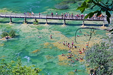 Tourists bathe at the waterfall Smotorcycleinski Buk, National Park Krka, Sibenik-Knin, Dalmatia, Croatia, Europe