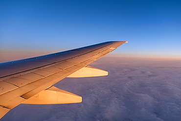 Wing of a plane, flight over clouds, dusk, sunset, Norway, Europe