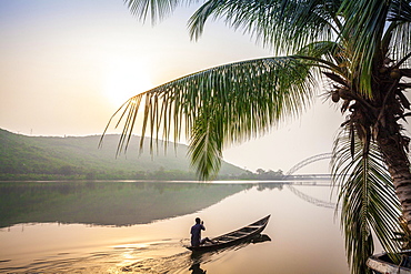 Local paddling in wooden canoe, Volta River, Ghana, Africa