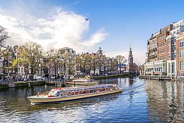 touristic boat on channel, back Mint tower, Amsterdam, Netherlands