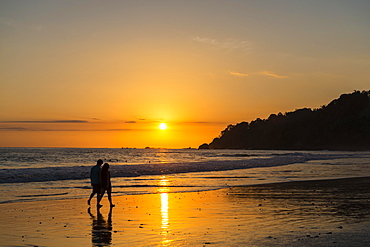 Man and woman strolling on the beach, sunset, Playa Espadilla, Manuel Antonio National Park, Costa Rica, Central America