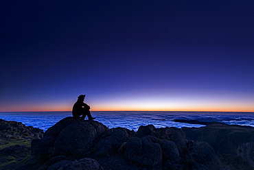 Sunrise with person on mountain peak, Pico de Arieiro, Funchal, Madeira