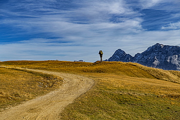 Trail with memorial cross and South Tyrolean mountains, St. Martin in Thurn, South Triol, Italy, Europe