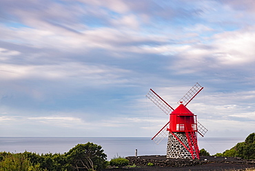 Red windmill in front of a cloudy sky, island of Pico, Azores, Portugal, Europe