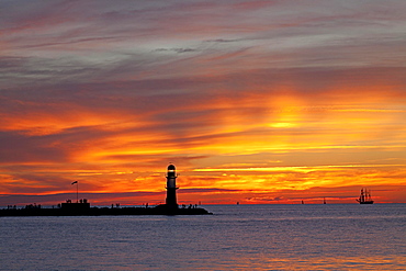 Sunset at bulwark, harbor entrance with lighthouse, Warnemunde, Rostock, Mecklenburg-Western Pomerania, Germany, Europe