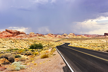 Lonely road through desert, thunderstorm forming, Valley of Fire, Nevada, USA, North America