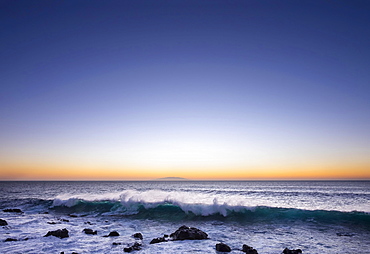 Ocean wave, surf, dusk, island of El Hierro behind, Valle Gran Rey, La Gomera, Canary Islands, Spain, Europe