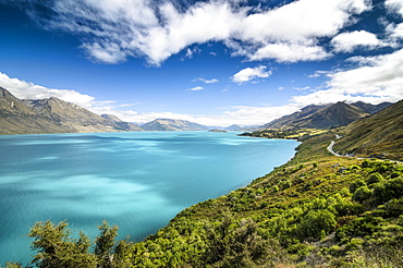 Blue sky with clouds over turquoise lake, Lake Wakatipu, right Glenorchy-Queenstown Road, New Zealand, South Island, Oceania