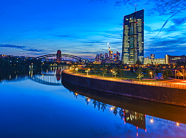 European Central Bank, ECB, at dusk in front of the illuminated skyline, roundabout at the Osthafen bridge, Frankfurt am Main, Hesse, Germany, Europe