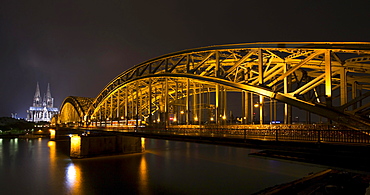 Hohenzollern Bridge, illuminated at night, Cologne Cathedral behind, Cologne, North Rhine-Westphalia, Germany, Europe