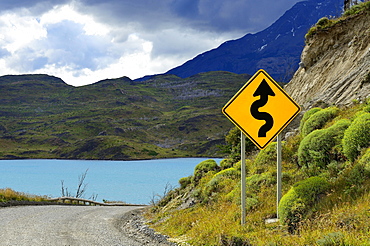 Road Sign Attention curves at Lago Pehoe, Torres del Paine National Park, Última Esperanza Province, Chile, South America