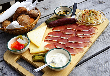 Snack plate with bacon, salami, gray cheese and horseradish on the Rossalm, Braies, Sexten Dolomites, South Tyrol, Italy, Europe