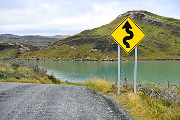 Sign Attention curves along the natural road, Laguna Amarga, Torres del Paine National Park, Última Esperanza Province, Chile, South America