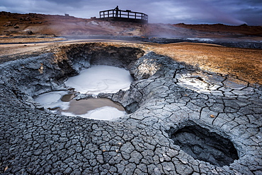 Solfataras, fumaroles, mud pots, sulfur and other minerals, a woman on the viewing platform at the back, high-temperature geothermal area or Hverarond or Hverir, Namafjall mountains, Myvatn area, Norourland eystra, Iceland, Europe