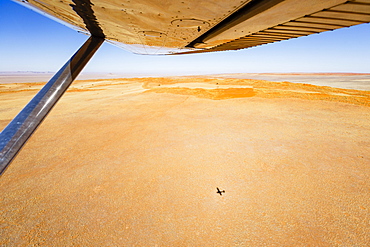 Aerial view, shadow of small aircraft on the ground, Namib Desert, Namib-Naukluft National Park, Namibia, Africa