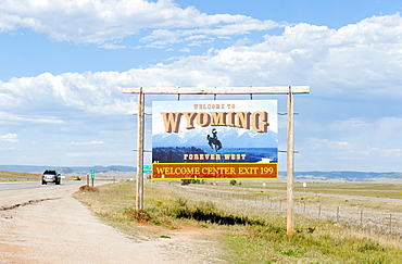 Welcome sign on a highway, ""Welcome to Wyoming, Forever West"", flat landscape, Wyoming, USA, North America